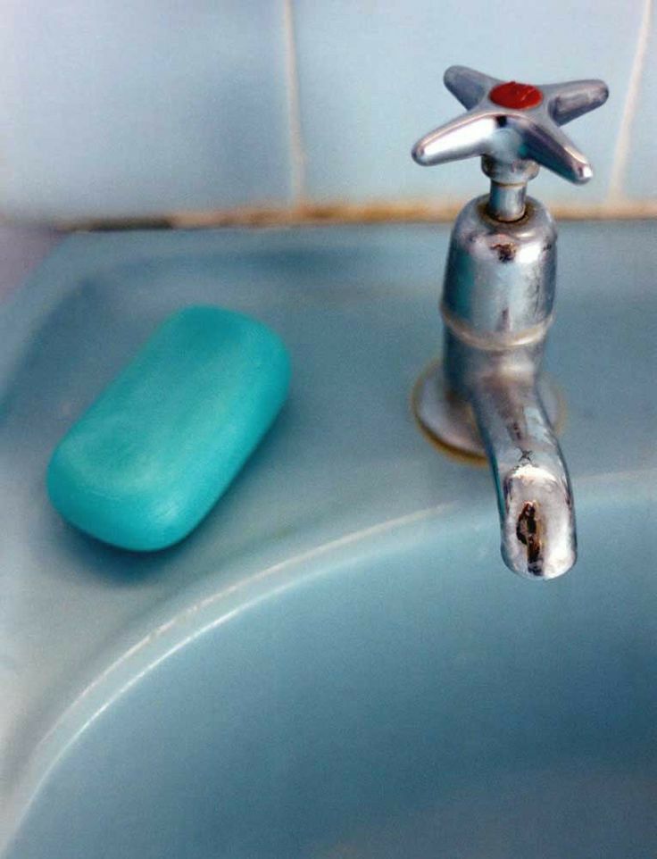 A worn tap and a bar of blue soap